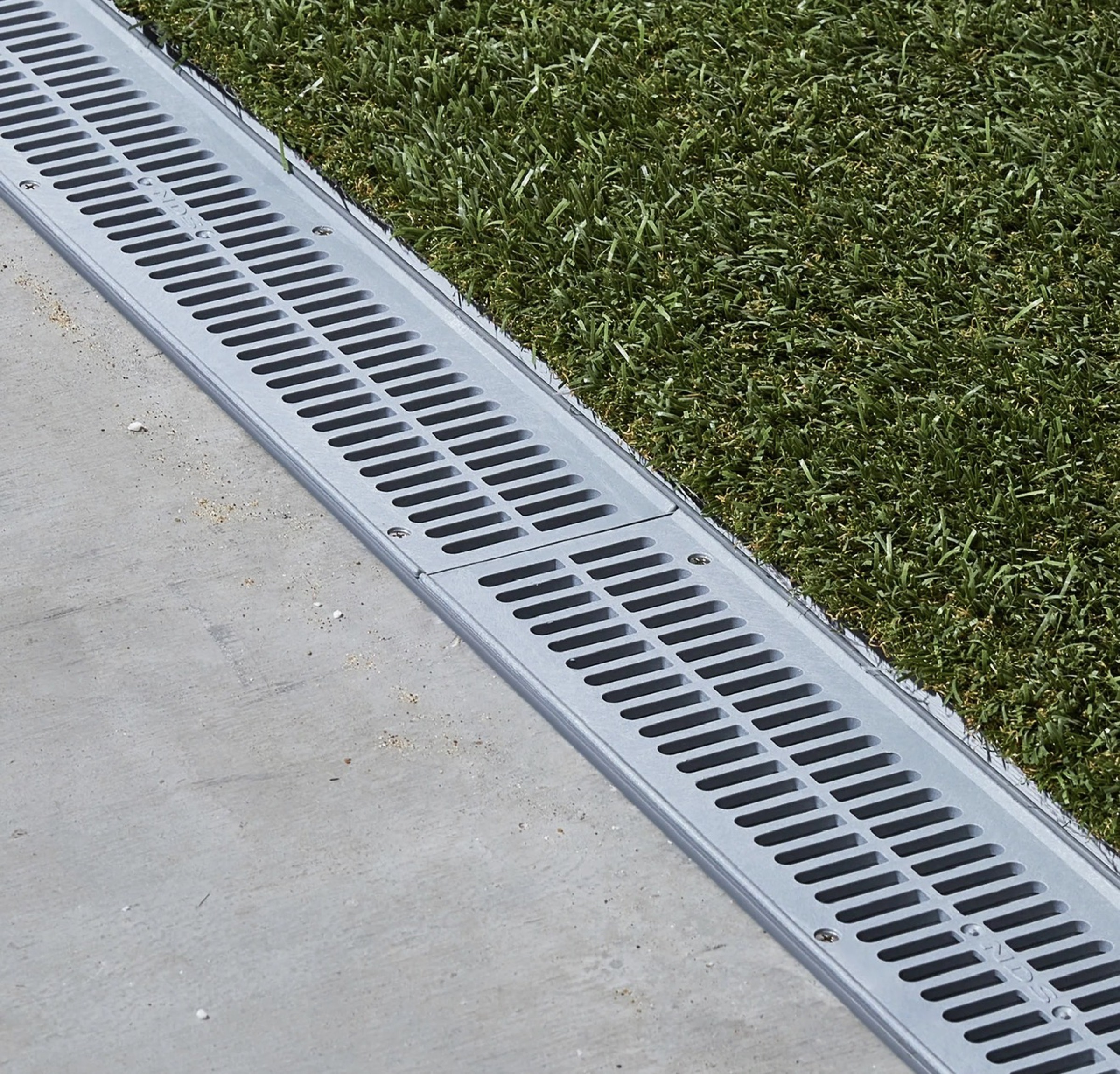 Channel drain set between a Houston walk and lawn