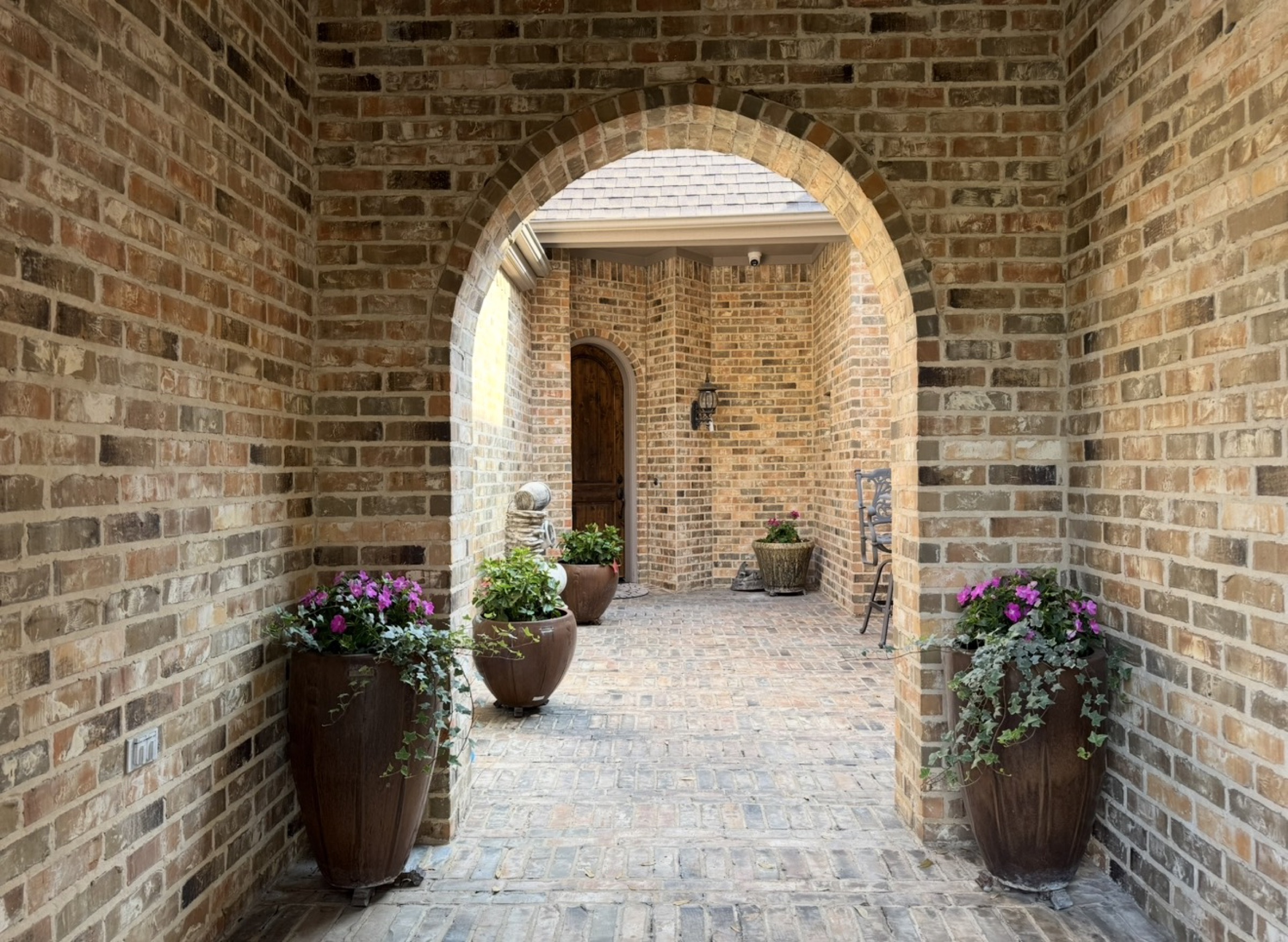 Potted color in a Houston brick entry