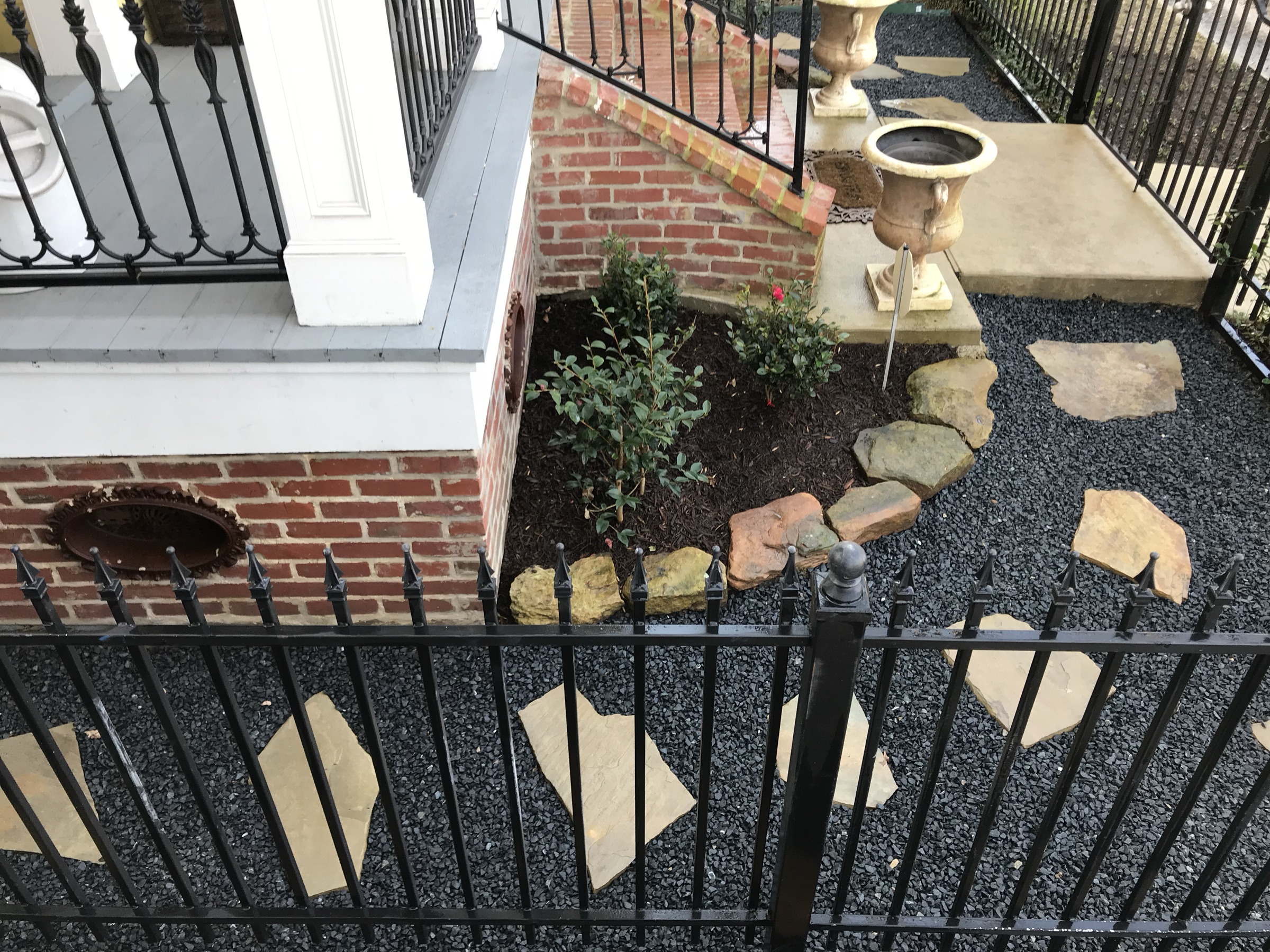 Brick outdoor steps with urns and flagstone on a Houston home