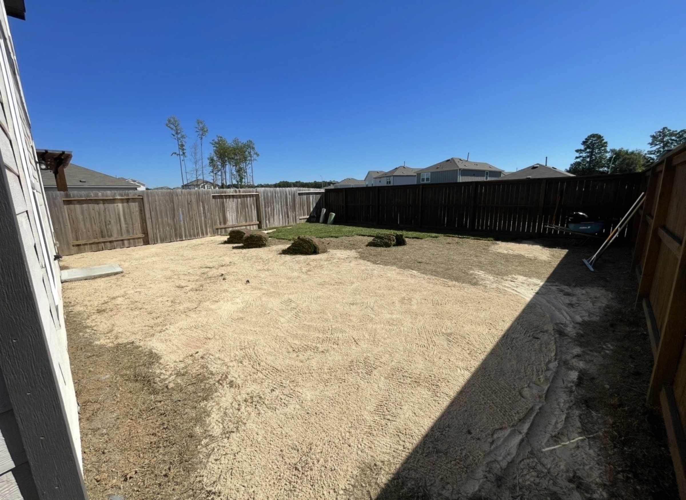 Houston backyard graded with sod rolls staged