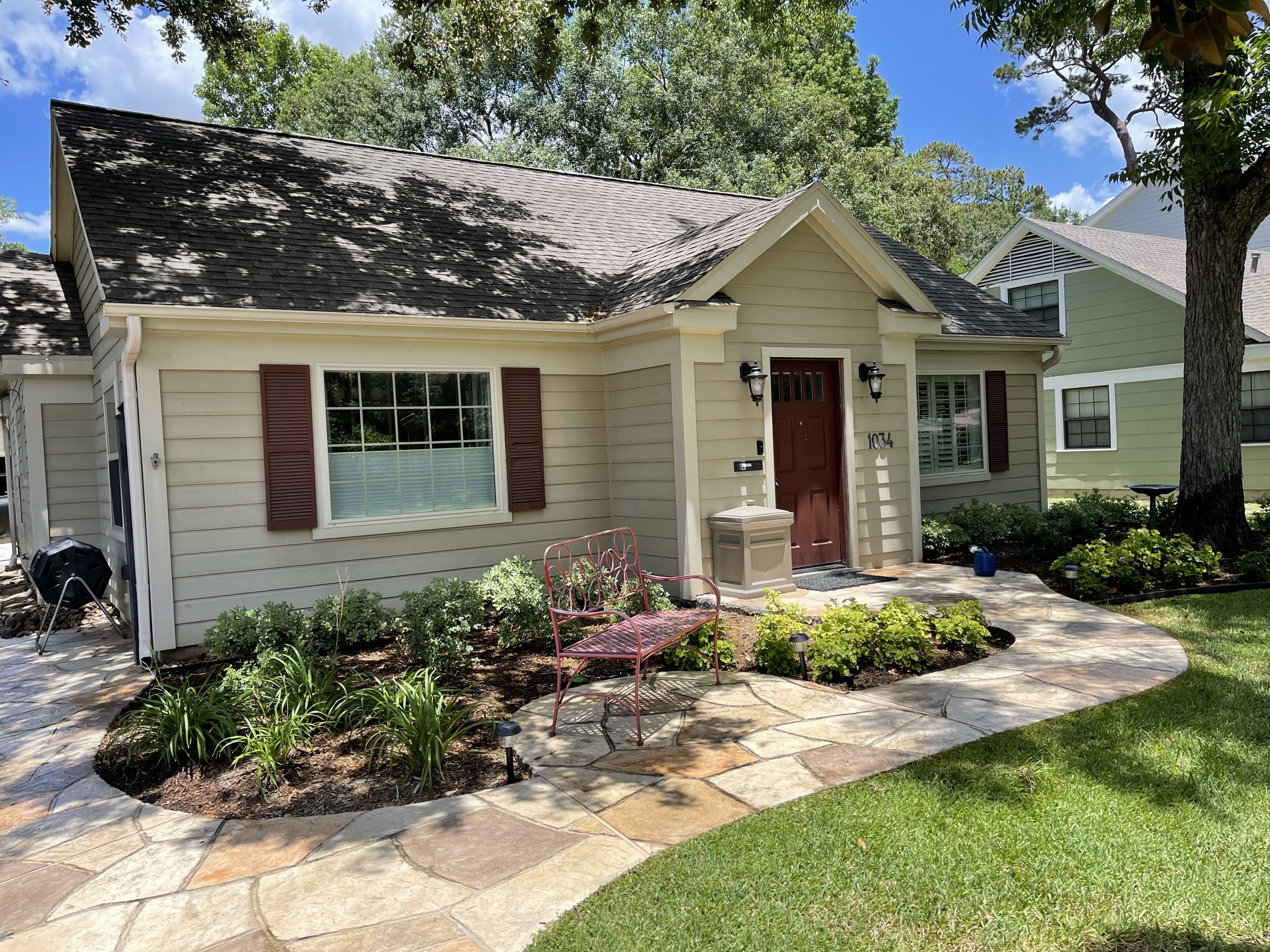 Flagstone walk and planted beds on a Houston cottage