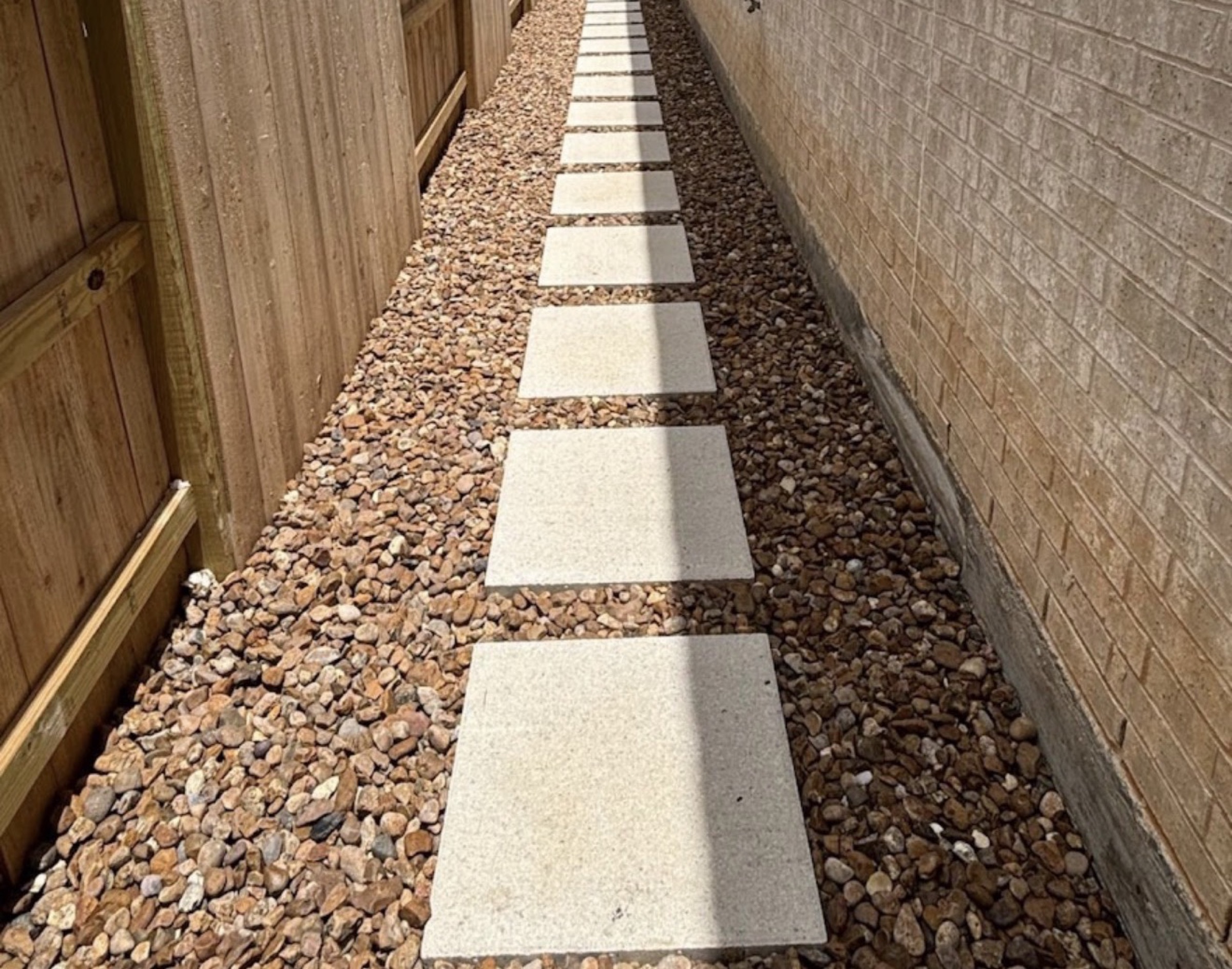 Square stepping stones in a Houston side yard