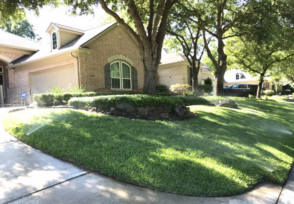 Landscaping company in Spring — bright residential lawn and flower beds